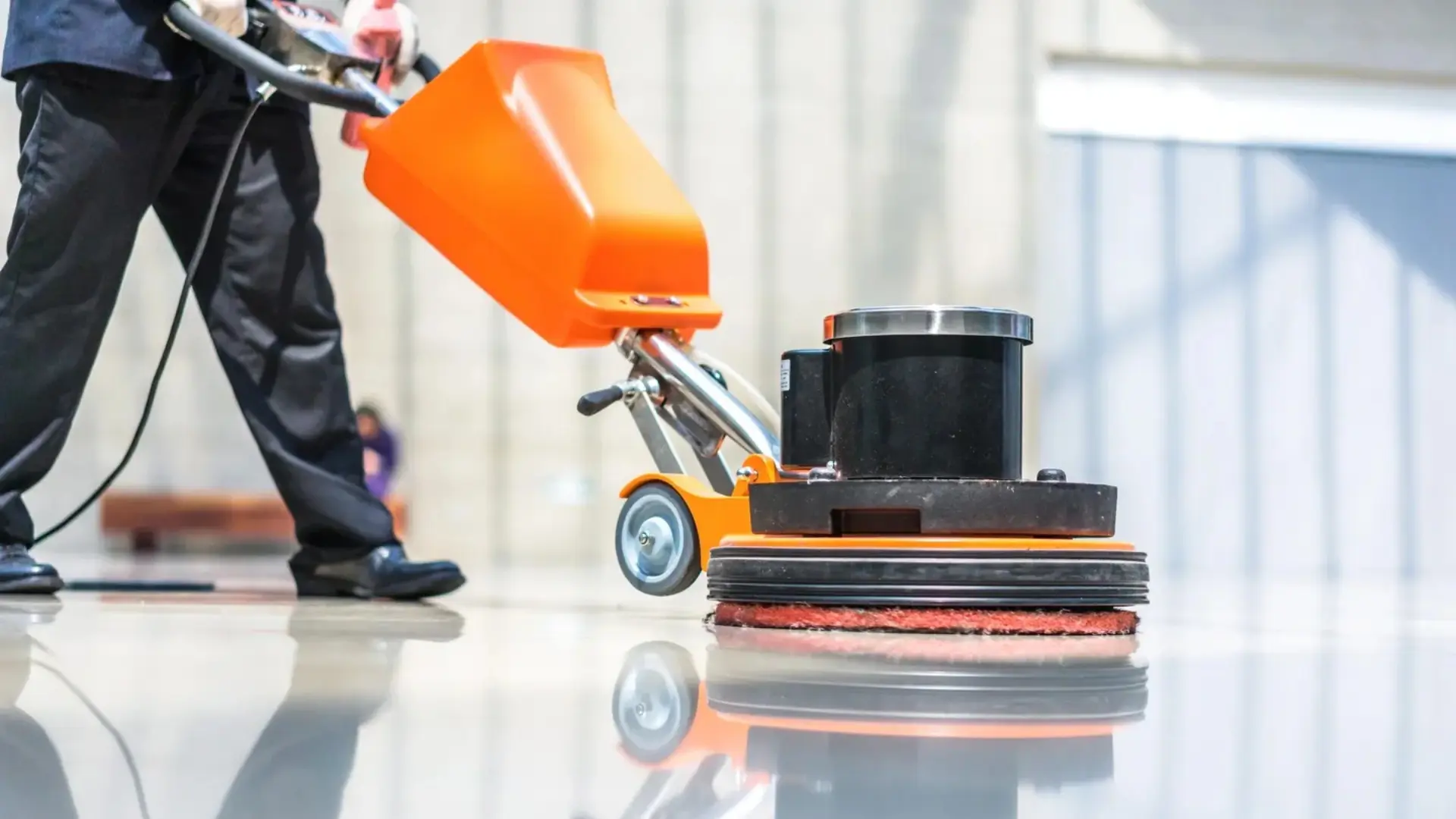 Floor polishing machine in use on tiles.